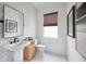 Chic powder room featuring marble herringbone floors, pedestal sink, and modern accents at 9990 Key Haven Rd, Seminole, FL 33777
