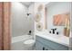 Stylish bathroom features light blue vanity, white backsplash, and woven decor at 9990 Key Haven Rd, Seminole, FL 33777