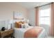 Cozy bedroom features soft lighting, peach accents, and a large window at 9990 Key Haven Rd, Seminole, FL 33777