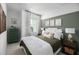Comfortable bedroom offers neutral tones, green accent wall, and soft textures at 9990 Key Haven Rd, Seminole, FL 33777