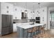 Modern kitchen featuring stainless steel appliances, a center island, and stylish pendant lighting at 9990 Key Haven Rd, Seminole, FL 33777