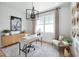 Bright home office featuring modern furniture, a stylish chandelier, and natural light at 9990 Key Haven Rd, Seminole, FL 33777