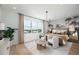 Tranquil bedroom with palm tree wallpaper and a cozy seating area by the bright window at 9992 Key Haven Rd, Seminole, FL 33777