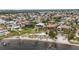 Waterfront property with a private beach, docks, and lush landscaping in aerial view at 103 Graham Se St, Port Charlotte, FL 33952