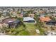 Bird's-eye view of a home with a screened pool, lush lawn, and tropical landscaping at 103 Graham Se St, Port Charlotte, FL 33952