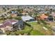 Aerial view highlighting the home's manicured lawn, mature landscaping, and canal-front location at 103 Graham Se St, Port Charlotte, FL 33952