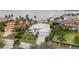 Stunning aerial view of waterfront home with lush landscaping and a paved driveway, situated near the open water at 103 Graham Se St, Port Charlotte, FL 33952