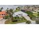 Charming waterfront home featuring tropical landscaping, a paved driveway, and serene water views from an elevated perspective at 103 Graham Se St, Port Charlotte, FL 33952