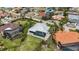 Stunning aerial view of a home featuring a screened pool and well-maintained lawn at 103 Graham Se St, Port Charlotte, FL 33952