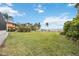 Expansive backyard with lush green grass and beautiful waterfront access and mature landscaping at 103 Graham Se St, Port Charlotte, FL 33952