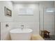 Bright bathroom featuring a soaking tub, a rain shower and a small window at 103 Graham Se St, Port Charlotte, FL 33952