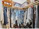 Organized walk-in closet with built-in shelving and hanging rods, offering ample storage space for clothing and accessories at 103 Graham Se St, Port Charlotte, FL 33952