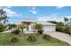 Beautiful two-story home with lush green lawn and lovely palms at 103 Graham Se St, Port Charlotte, FL 33952