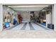 A spacious three car garage with tile flooring and storage, perfect for hobbies and tools at 103 Graham Se St, Port Charlotte, FL 33952