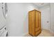 Bright laundry room with wood cabinet and stacked washer and dryer for a convenient space at 103 Graham Se St, Port Charlotte, FL 33952