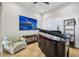 Bright room features a baby grand piano, neutral walls, and tile floors, illuminated by natural light from shuttered windows at 103 Graham Se St, Port Charlotte, FL 33952