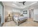 Relaxing main bedroom with travertine flooring, a four-poster bed, and sliders to the lanai, plus ensuite bathroom at 103 Graham Se St, Port Charlotte, FL 33952