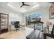 Bright home office with desk, computer, treadmill, and sliding glass doors to the pool area at 103 Graham Se St, Port Charlotte, FL 33952