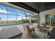 Inviting screened patio with comfortable seating, beautiful pool, and scenic waterfront at 103 Graham Se St, Port Charlotte, FL 33952