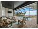 Relaxing screened patio featuring comfortable seating, a pool, and stunning waterfront views at 103 Graham Se St, Port Charlotte, FL 33952