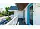 Intimate balcony with a blue door and painted wood flooring, offering an inviting outdoor space at 10311 Waterbird Way, Bradenton, FL 34209