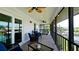 Cozy screened-in patio features comfortable seating, offering a relaxing space to enjoy the beautiful waterfront views at 10311 Waterbird Way, Bradenton, FL 34209