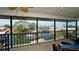 Relaxing screened-in balcony with comfortable seating offers scenic views of the waterfront and lush surroundings at 10311 Waterbird Way, Bradenton, FL 34209