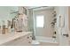 Bright bathroom with stylish fixtures, including a white vanity and a tiled shower and tub combination at 10311 Waterbird Way, Bradenton, FL 34209
