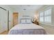 Comfortable bedroom featuring white shuttered windows and a woven headboard, creating a cozy and inviting space at 10311 Waterbird Way, Bradenton, FL 34209