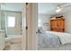 Bedroom leading to a tiled bathroom creating a convenient and private retreat at 10311 Waterbird Way, Bradenton, FL 34209