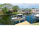 View of the canal with a boat, boat lift, dock, seawall and waterfront homes at 10311 Waterbird Way, Bradenton, FL 34209
