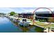 Waterfront property with boat lift, lush landscaping, and a cozy patio area, perfect for enjoying waterfront living at 10311 Waterbird Way, Bradenton, FL 34209