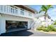 Well-maintained two-story home featuring an open garage and exterior staircase at 10311 Waterbird Way, Bradenton, FL 34209