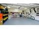 Organized garage with ample storage cabinets, shelving, and a convenient side door at 10311 Waterbird Way, Bradenton, FL 34209
