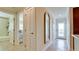 Hallway showcases the access to bathroom and bedroom, complemented by tiled floors and natural lighting at 10311 Waterbird Way, Bradenton, FL 34209