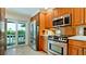 Well-equipped kitchen with modern appliances and access to outdoor balcony at 10311 Waterbird Way, Bradenton, FL 34209