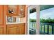 Kitchen detail of cabinets and view through sliding door to outdoor balcony at 10311 Waterbird Way, Bradenton, FL 34209