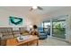 Bright living room with tile floors, comfortable seating, and sliding glass doors to screened in lanai at 10311 Waterbird Way, Bradenton, FL 34209