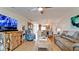 Open concept living room and dining area with tile floors, comfortable seating, and water views at 10311 Waterbird Way, Bradenton, FL 34209