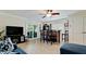 Open living room area with a ceiling fan and sliding glass doors to the outdoor patio at 10311 Waterbird Way, Bradenton, FL 34209