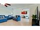 Comfortable living room showcases blue furniture and tile flooring throughout the house at 10311 Waterbird Way, Bradenton, FL 34209
