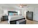 Comfortable bedroom with neutral colors, tile flooring, and en-suite bathroom at 10311 Waterbird Way, Bradenton, FL 34209