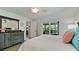 Bedroom with tile flooring, ceiling fan, and sliding door to screened balcony at 10311 Waterbird Way, Bradenton, FL 34209