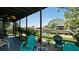 Screened lanai offers a serene waterfront view and features comfortable seating for relaxation and entertainment at 10311 Waterbird Way, Bradenton, FL 34209