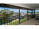 View of the canal from the screened porch with string lights, and black metal safety railing at 10311 Waterbird Way, Bradenton, FL 34209