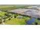 Aerial showcases the property, including the pool, detached garage, lawn and nearby farm, offering space and seclusion at 18307 White Fang Ct, Parrish, FL 34219