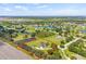 Beautiful aerial view of the home's location within a quiet community, with a pond and ample land at 18307 White Fang Ct, Parrish, FL 34219