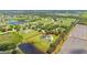 An aerial view of the property outlines the house, expansive yard, and a peaceful pond, offering a private oasis at 18307 White Fang Ct, Parrish, FL 34219