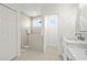 Bright bathroom with a shower, white cabinets, and modern fixtures at 18307 White Fang Ct, Parrish, FL 34219