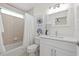 Bright bathroom featuring vanity with white stone countertop and tile tub-shower combo at 18307 White Fang Ct, Parrish, FL 34219